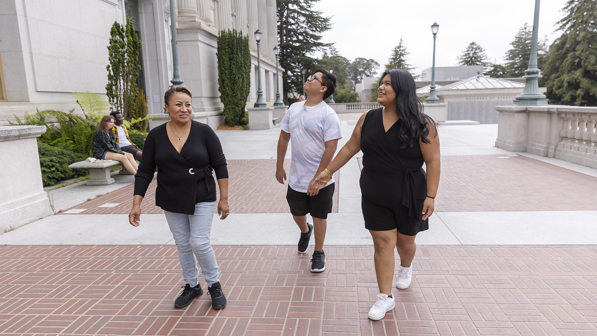 Natalie walks on UC Berkeley's campus with her mom and younger brother.