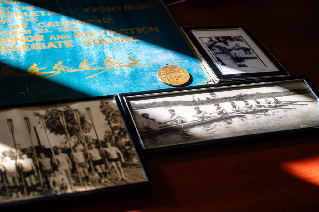 an image of several other images laying on a table showing people rowing a boat and a medal situated in the middle of the frame