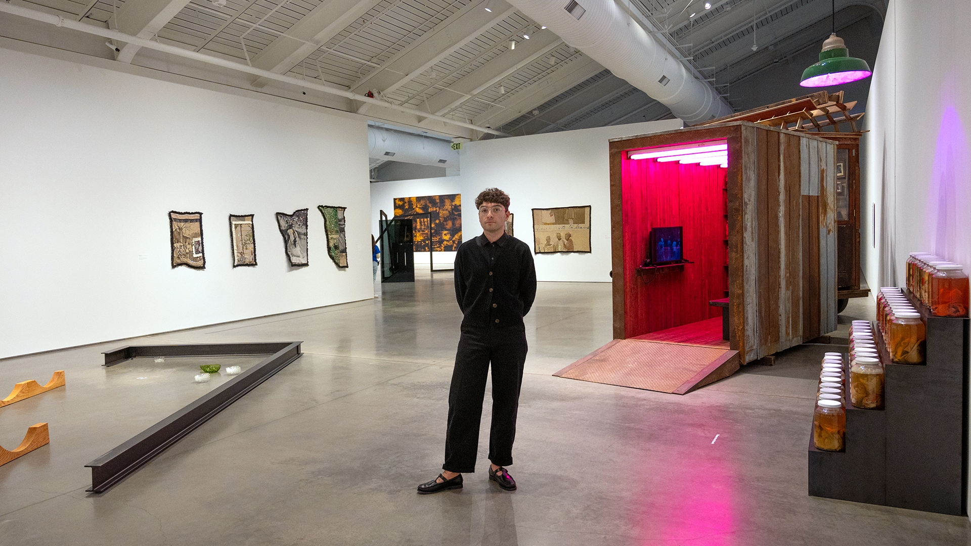 Anthony stands in a gallery at BAMPFA