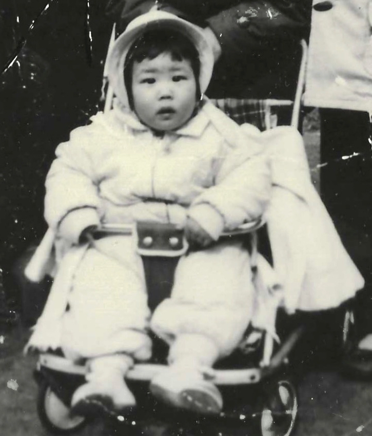 Baby picture of Carol Mimura siting in a stroller.