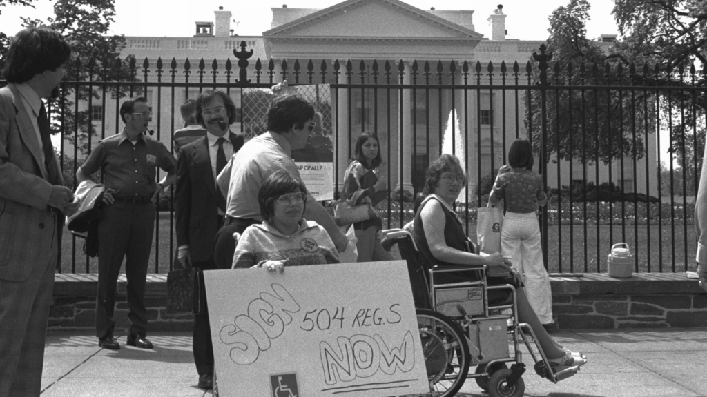 Black-and-white photo of Judy Heumann at a rally for disability rights in Washington D.C.