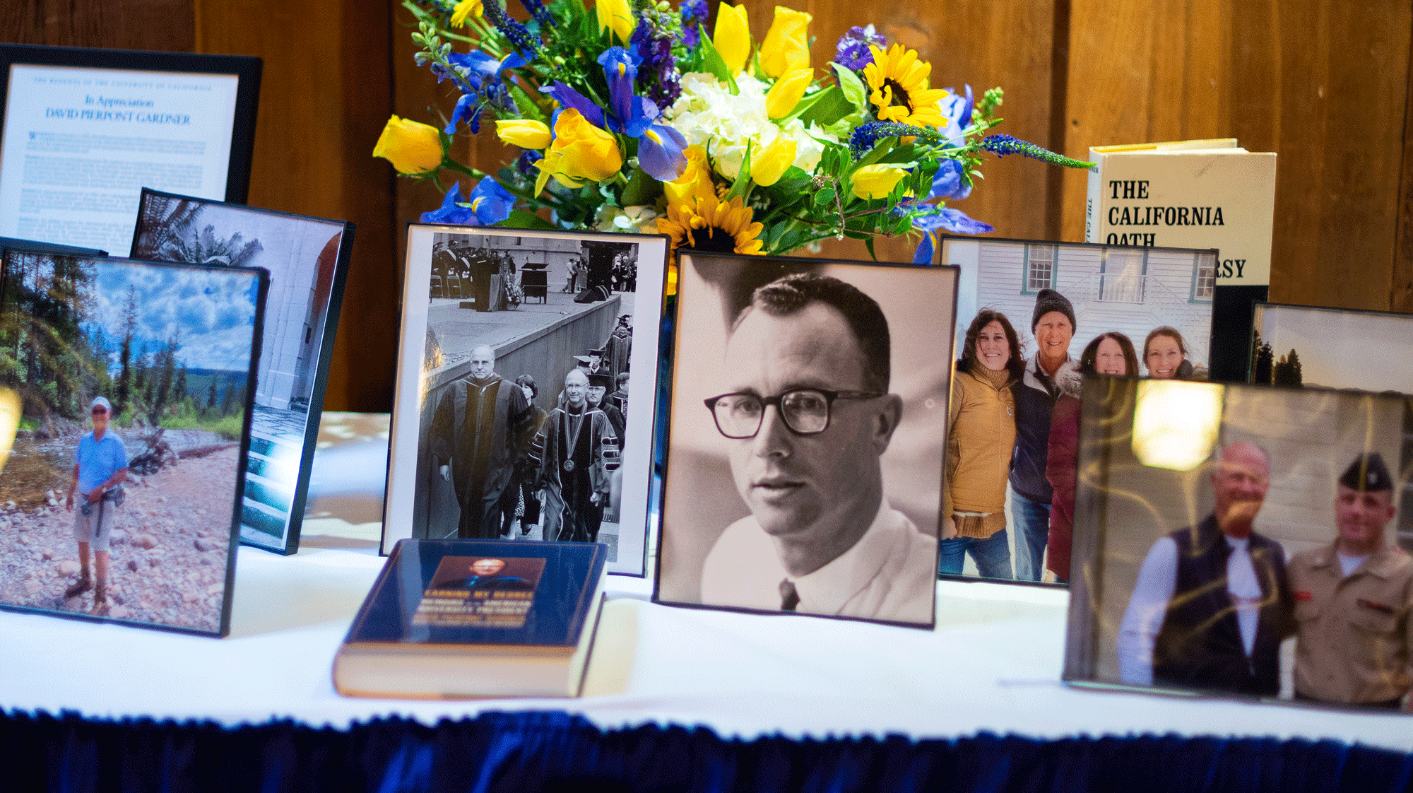 Photos, books and a bouquet adorned a table at the memorial event for former UC President David P. Gardner 