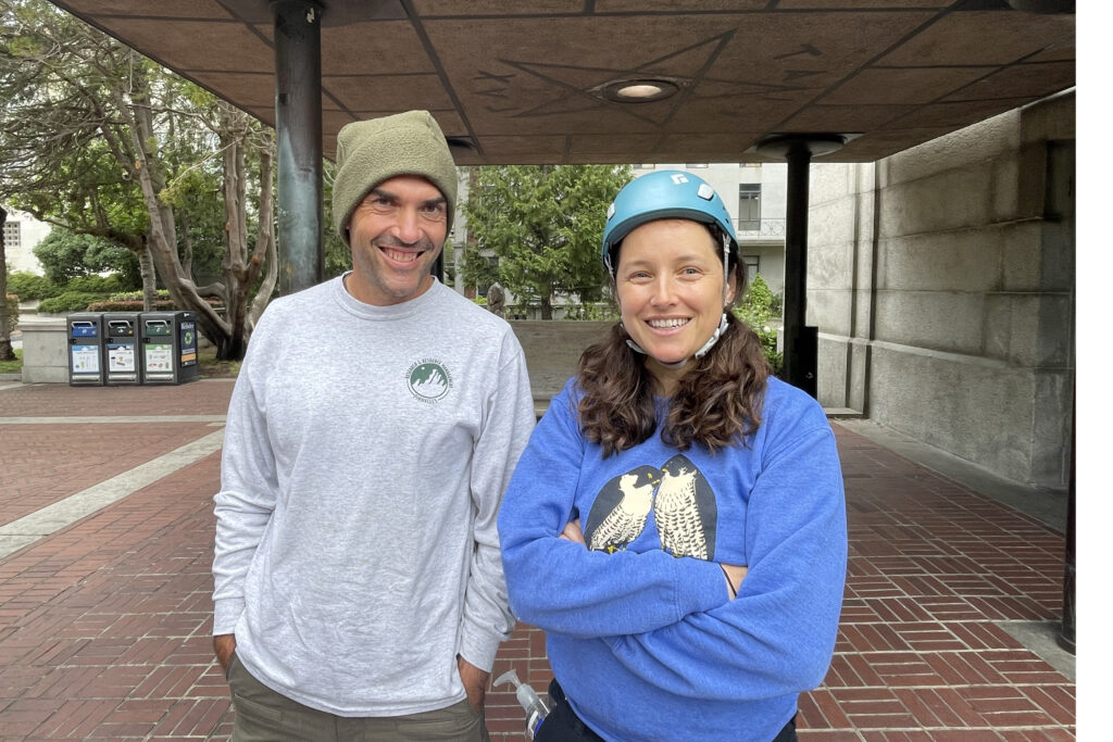 Gavin Emmons and Zeka Glucs stand at the entrance to the Campanile after banding the 2024 falcon chicks earlier in the day. Zeka is wearing a Cal Falcons sweatshirt.