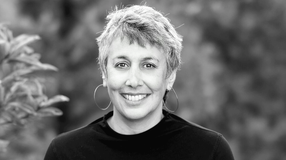 Geeta Anand, dean of Berkeley Journalism, smiling in an informal black-and-white portrait