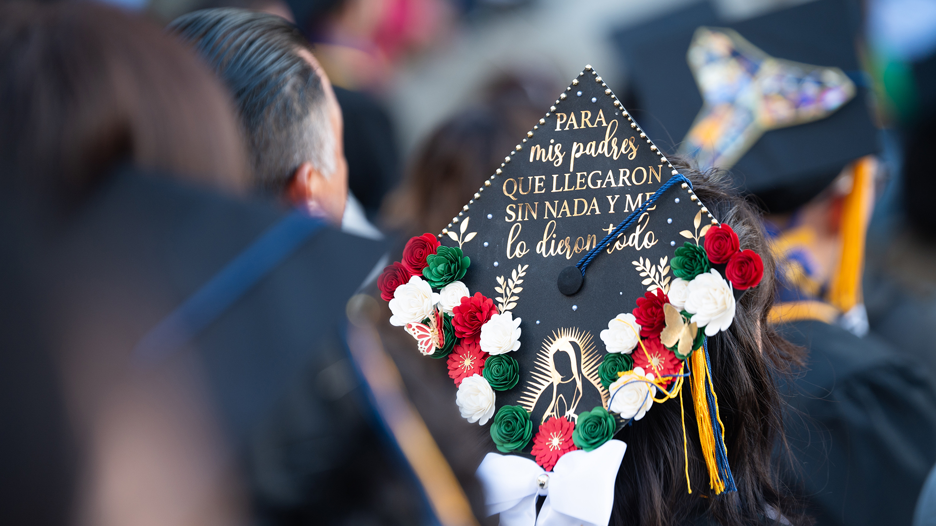 A student's graduation mortar board reads: 