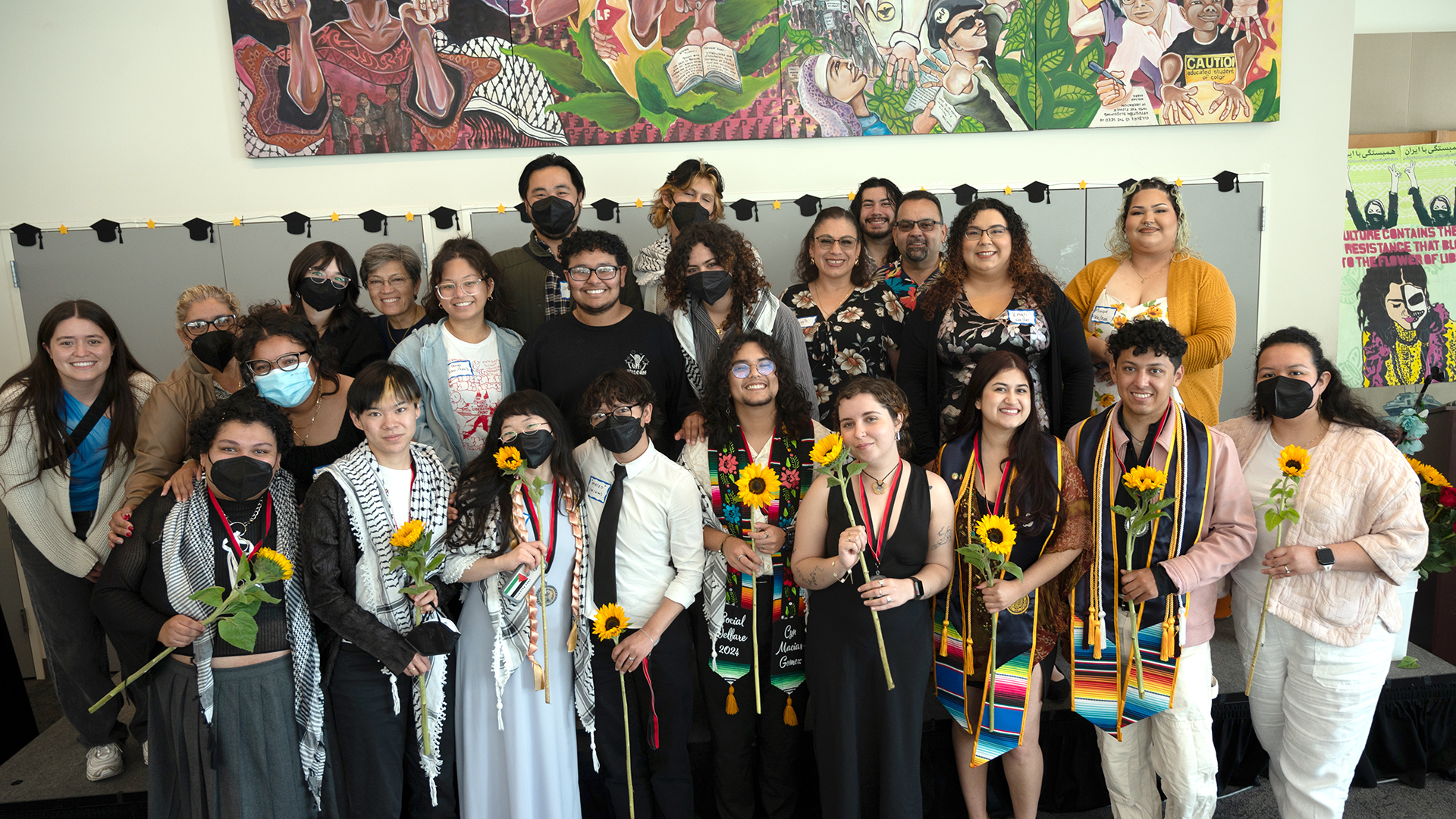 About 30 students, staff and faculty connected with Berkeley's Multicultural Community Center pose for a group photo