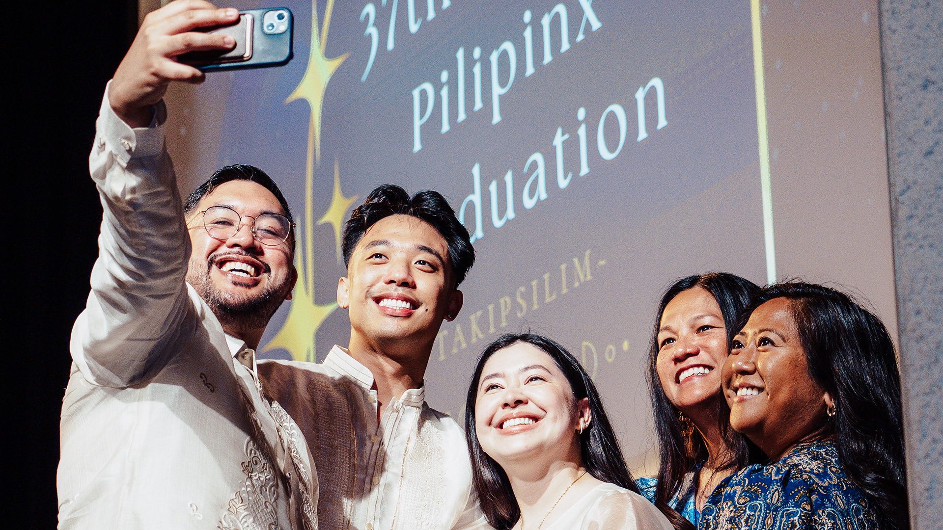 Five people at the Pilipinx graduation take a selfie