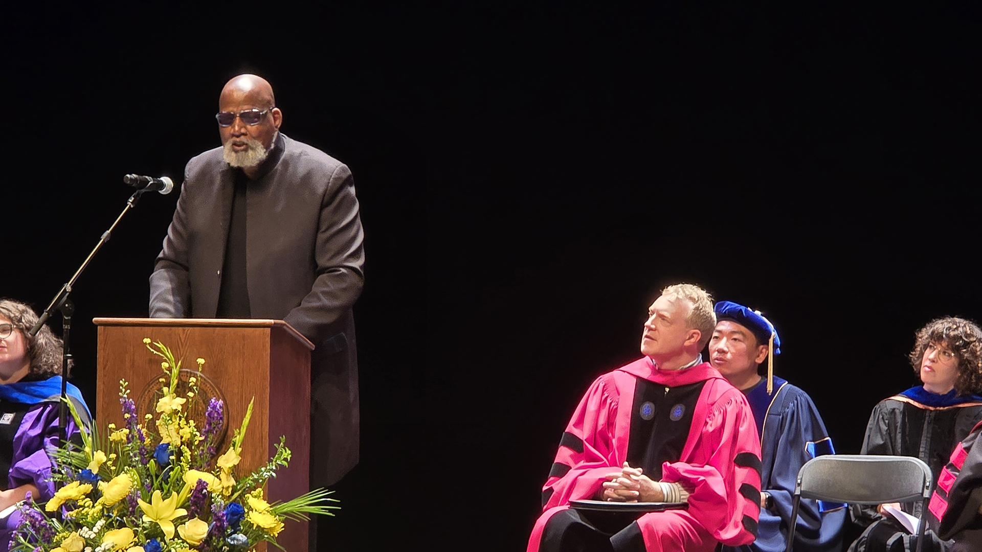 Harry Edwards gives a commencement speech at a podium