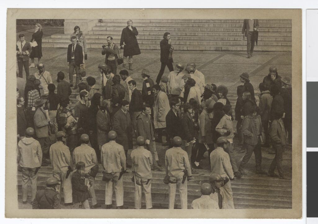 A black and white photo of people gathered at Sproul Hall