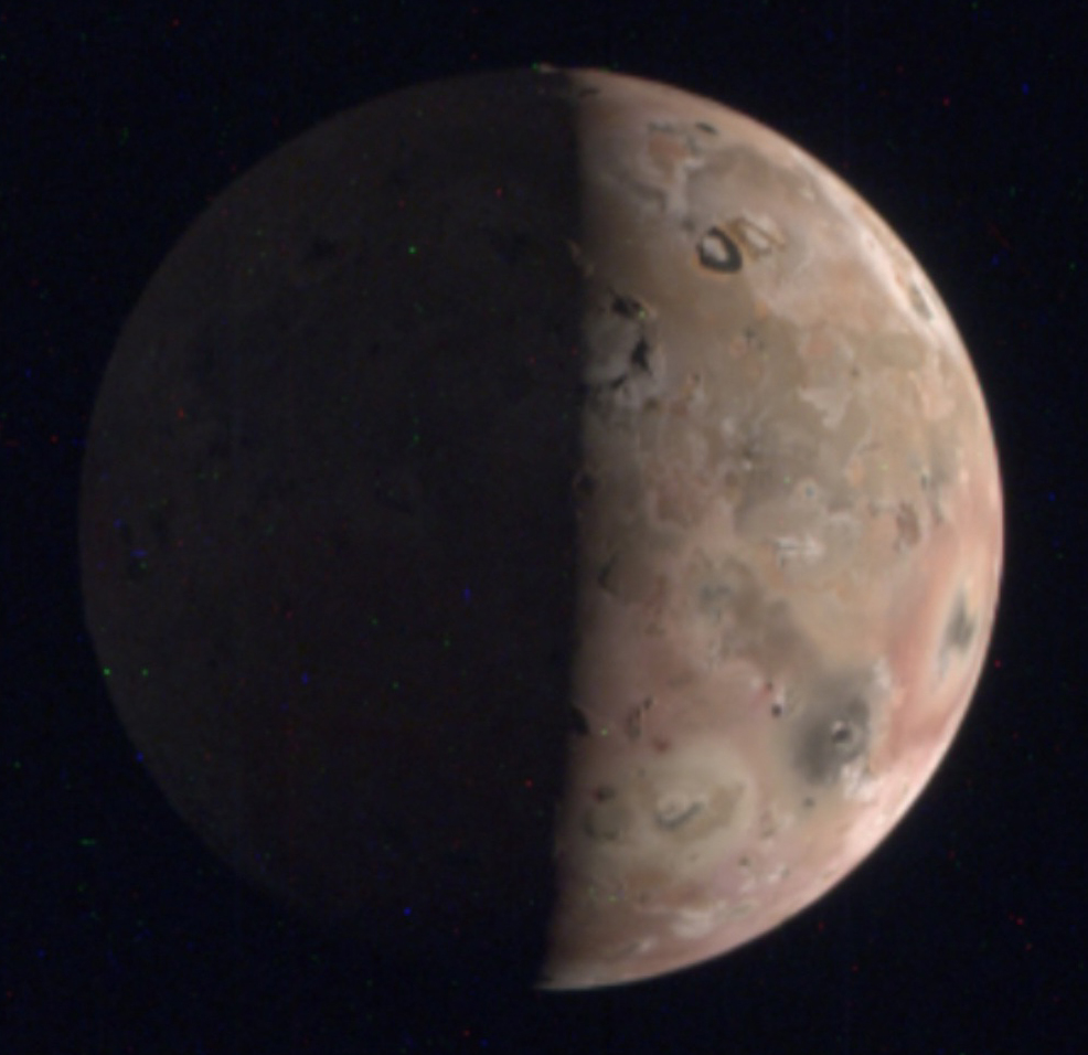 Io in eclipse, showing a mottled reddish surface