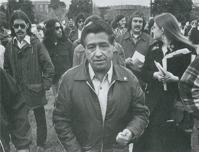 Archival black and white image of Cesar Chavez with other activists.