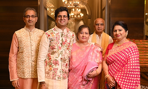 Saagar with his parents, older brother and his aunt at a wedding in India. They are all wearing traditional Indian attire.