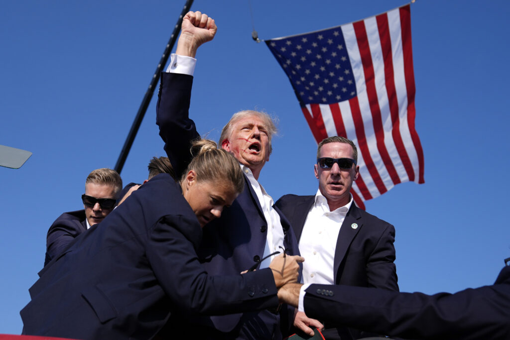 Republican presidential candidate former President Donald Trump is surrounded by U.S. Secret Service agents at a campaign rally