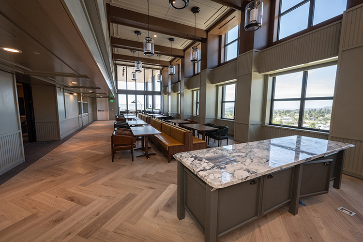 The 13th floor of Anchor House has a sophisticated meeting spot for campus events. There is a herringbone-patterned wood floor, moveable tables and chairs, a terrace with Bay Area views and an elevator with direct access from the ground floor to a reception area and a full-service kitchen.