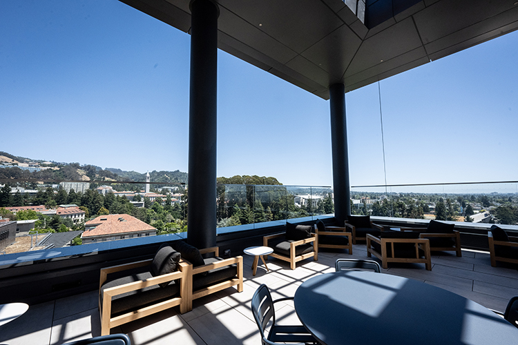 An outdoor terrace on the 13th floor of Anchor House is called the Sun Terrace and is filled with tables and chairs, cushioned seats for relaxing and potted plants.