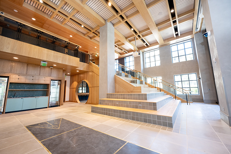 An area with terraced seating called The Hill is a place where Anchor House residents can sit and watch movies on a giant pull-down screen. The steps are made of tile and wood and lots of light pours in from two stories of windows.