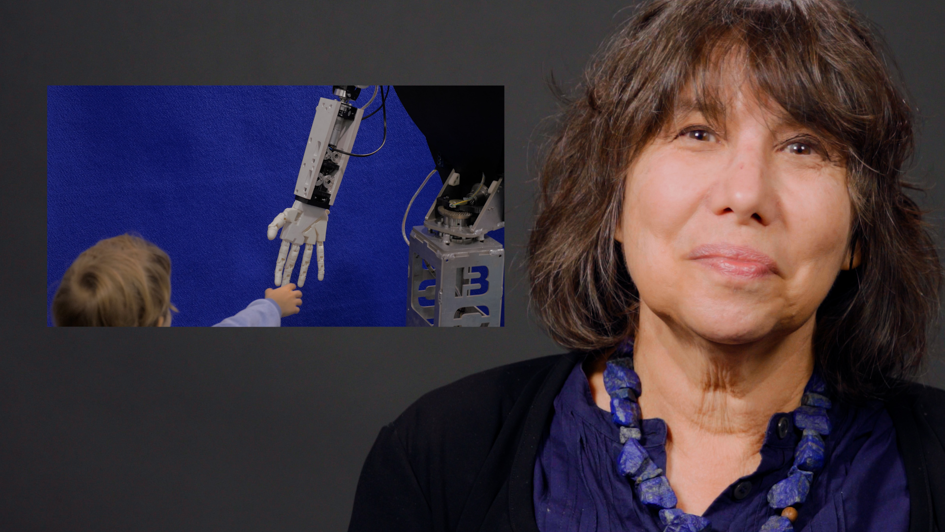 UC Berkeley psychology professor Alison Gopnik looks into the camera, next to a still picture of a robot hand reaching out towards a baby's hand.