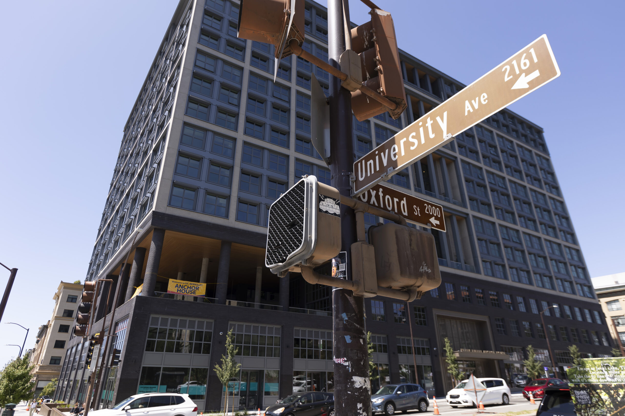 Street signs indicate the corner of University Avenue and Oxford Street, and behind them is Anchor House, the new housing complex designed especially for transfer students that opened for the first time in August 2024.