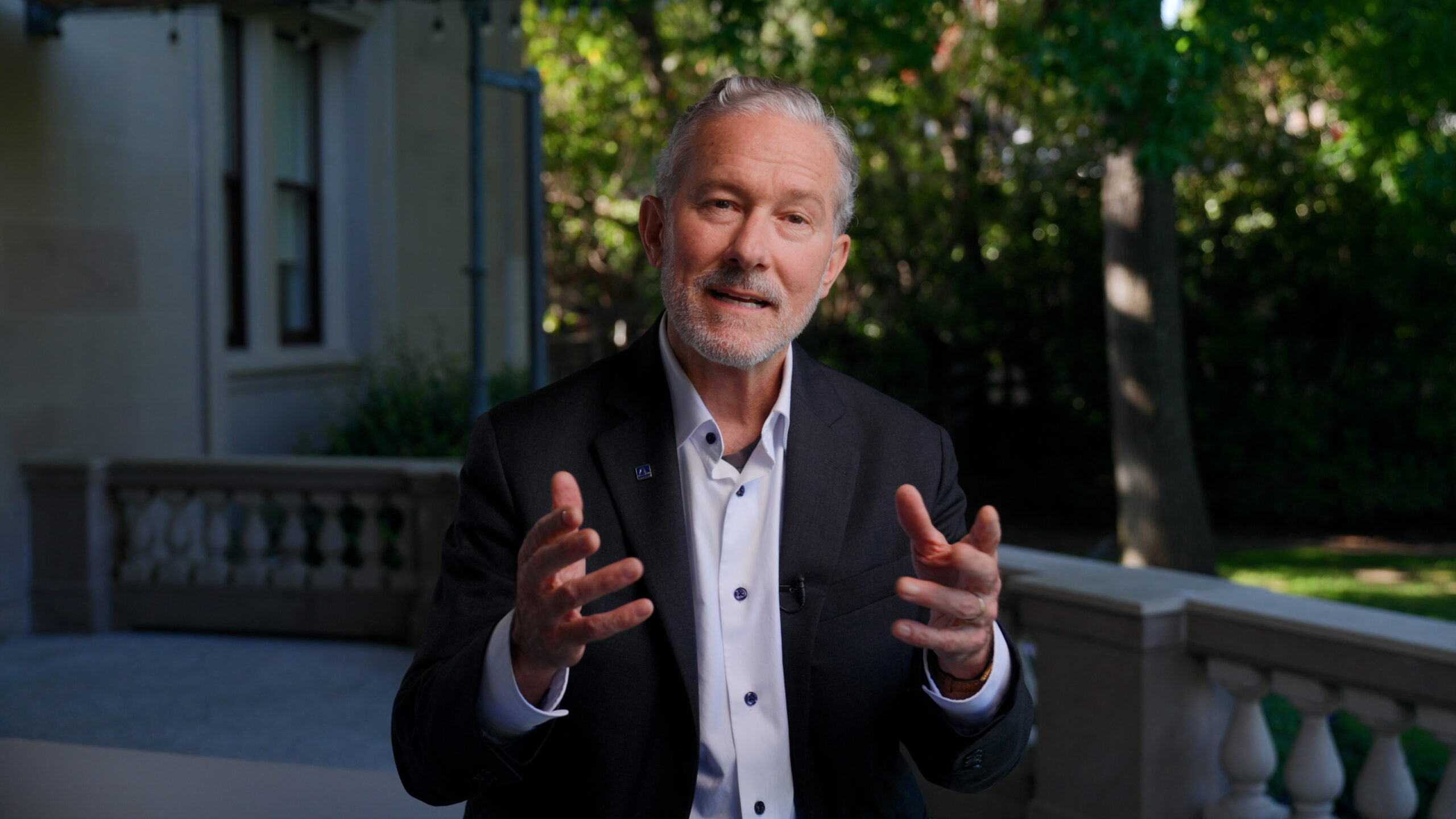 Chancellor Rich Lyons gestures towards the camera as he speaks towards the viewer.