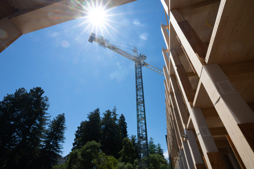 A crane hovers over the construction site for the new Undergraduate Academic Building that's being built behind Dwinelle Hall.