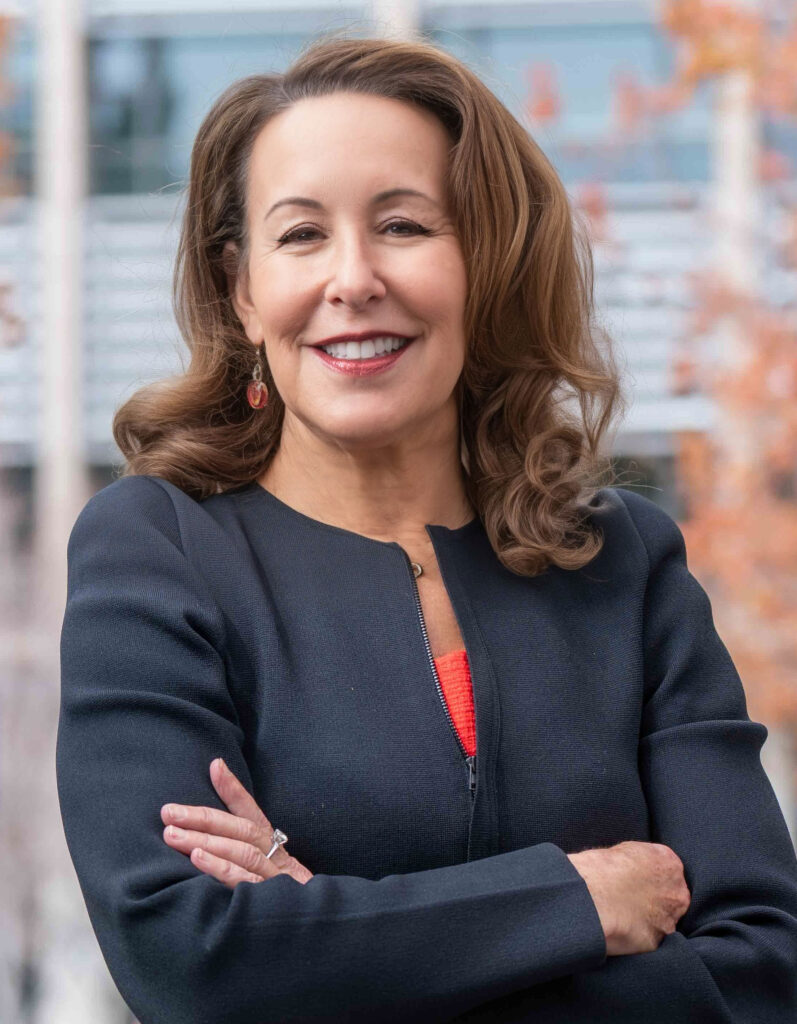 casual vertical portrait of Jennifer Chatman, smiling with arms crossed