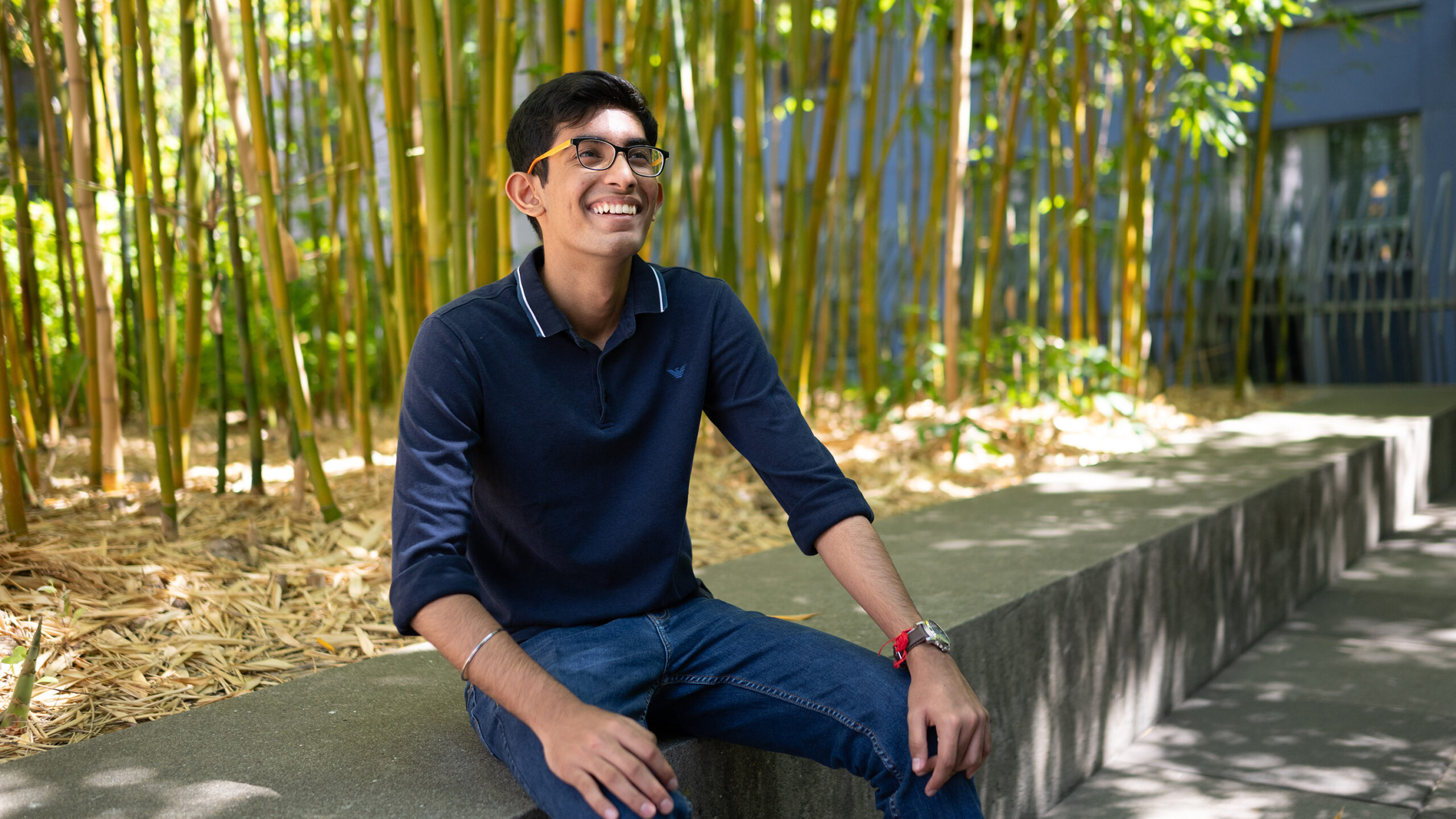 Vihaan smiles while sitting in a courtyard at Berkeley