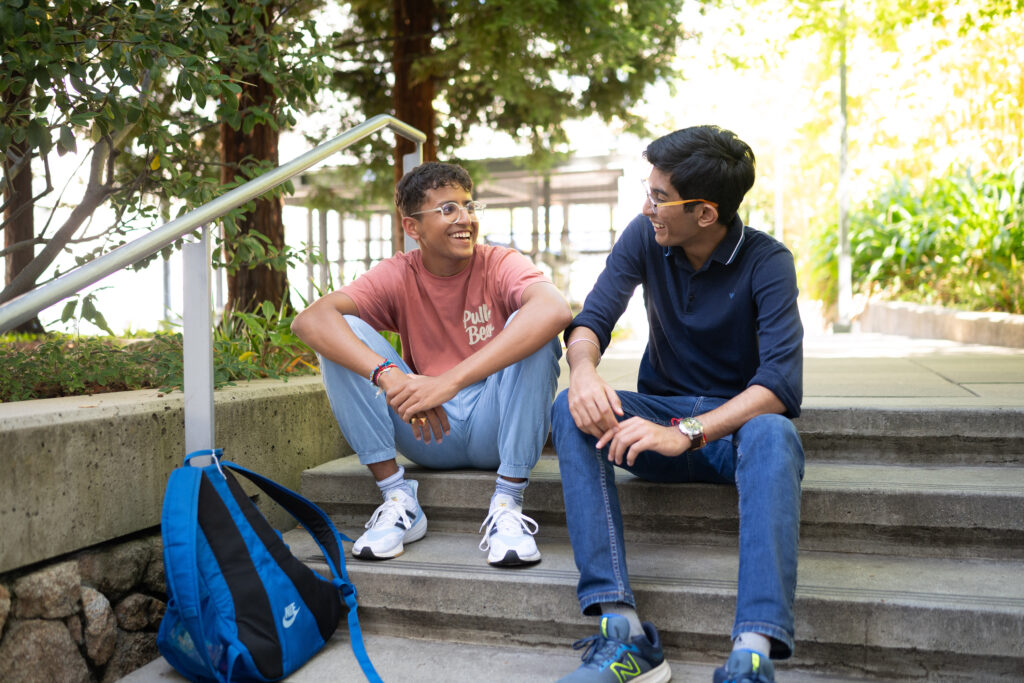 Vihaan sits with his new roomate, Kian, on some steps outside on UC Berkeley's campus