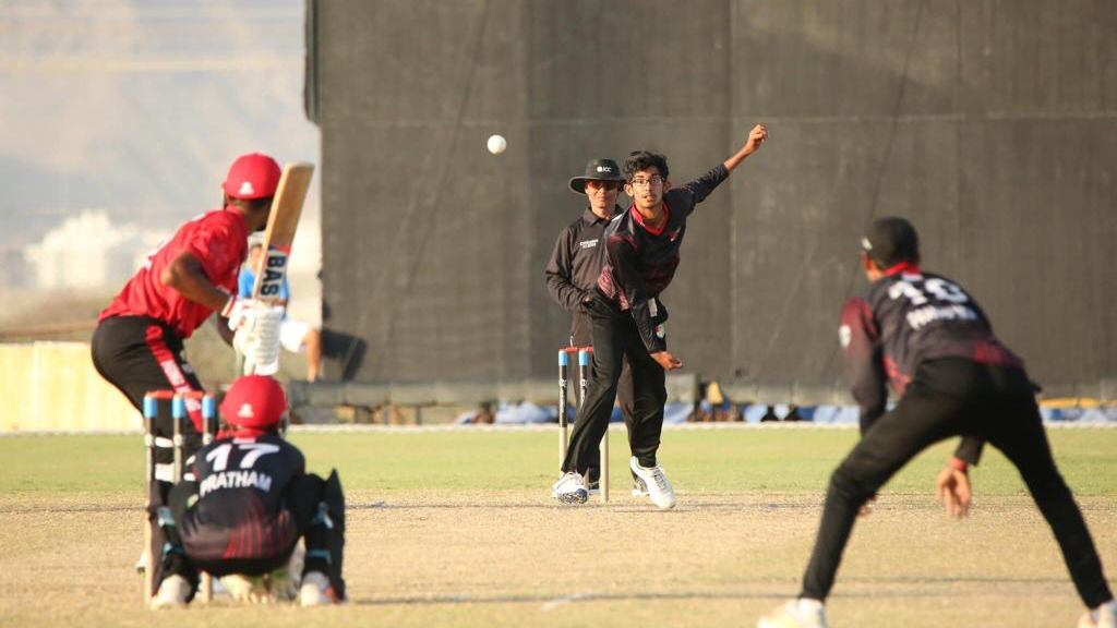 Vihaan just after he bowls during a cricket math with a batter about to hit the ball, which is in mid-air