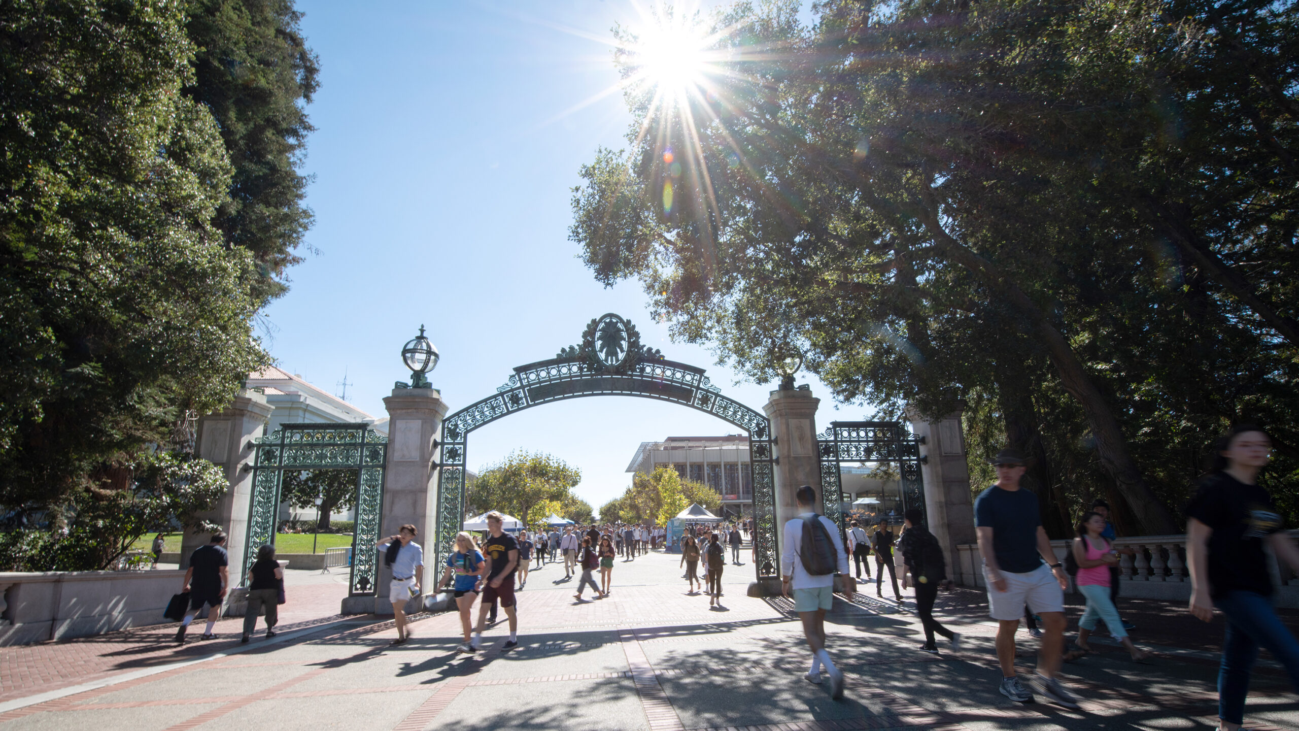 Students walk under Sather Gate on UC Berkeley's campus