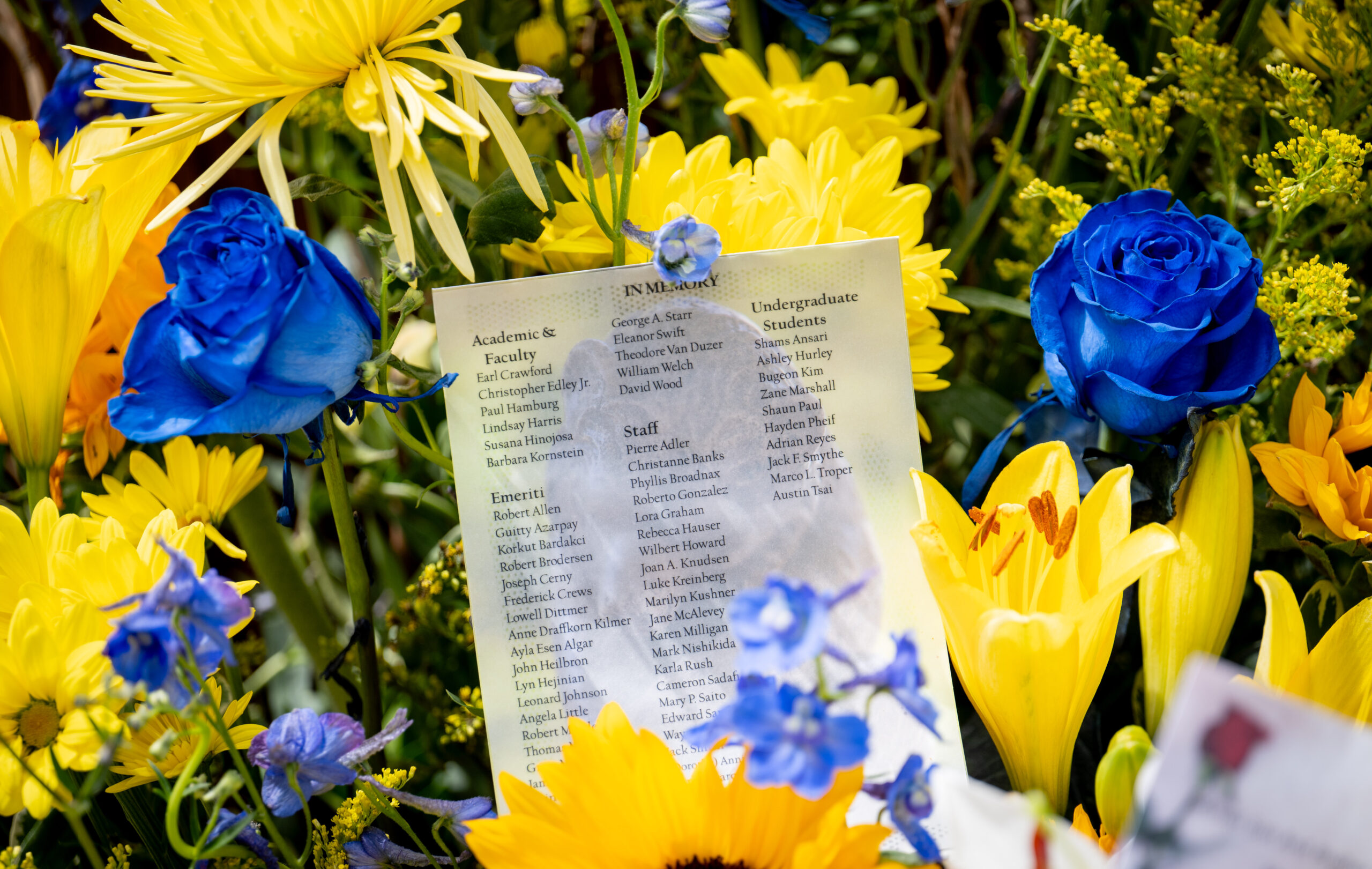 A program of those remembered at the event is pictured, laid amongst flowers.