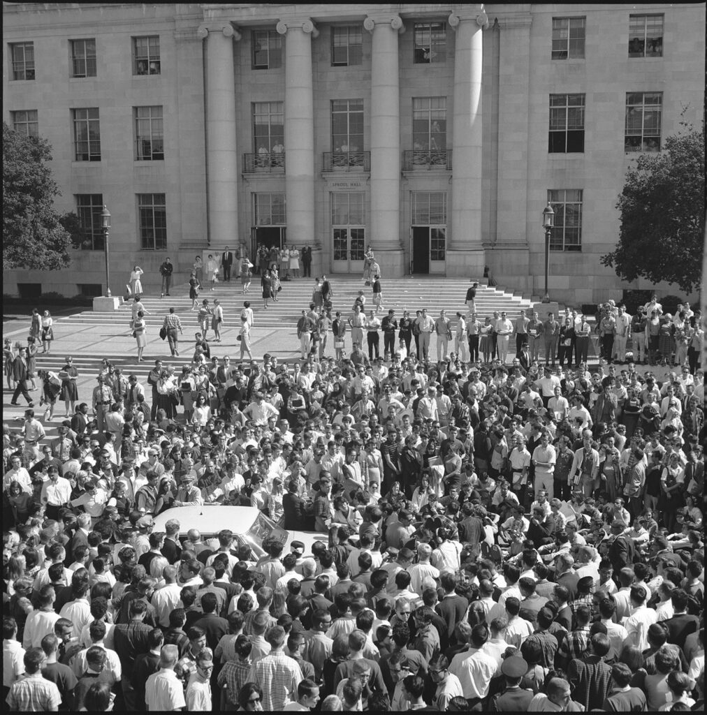 A crowd of hundreds of people gather in protest on UC Berkeley's Sproul Plaza in 1964.