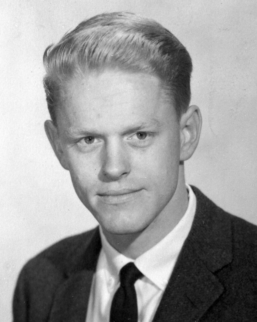 black and white photo of a young man in suit and tie