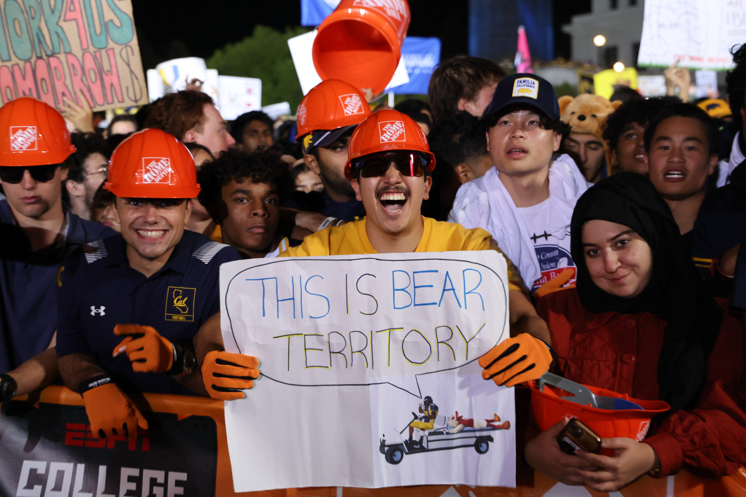 A Cal fan holds a sign that reads 