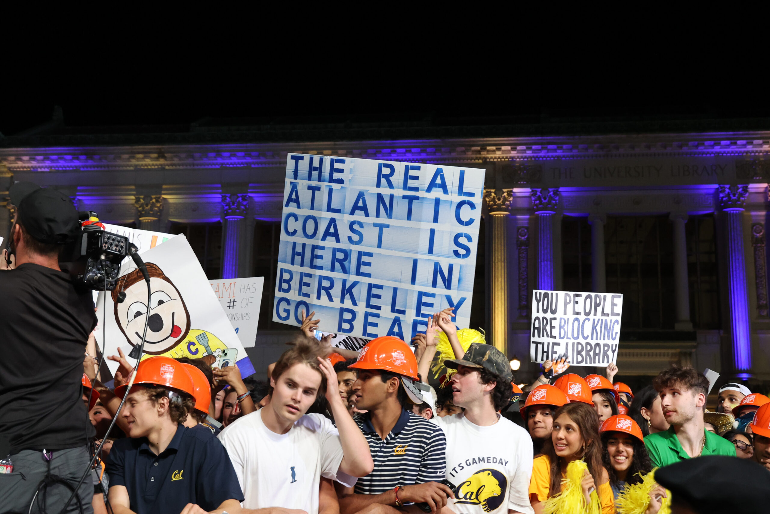 Cal fans hold signs that read 