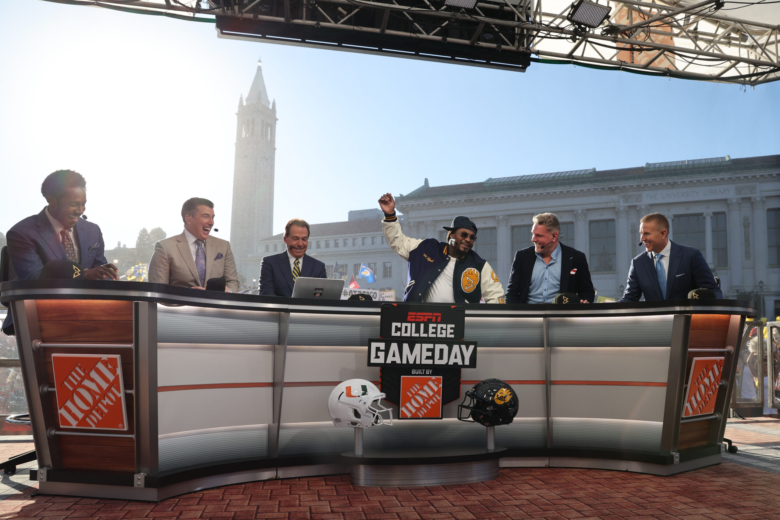 Marshawn Lynch gets hyped up surrounded by the hosts of GameDay from the broadcast's desk.