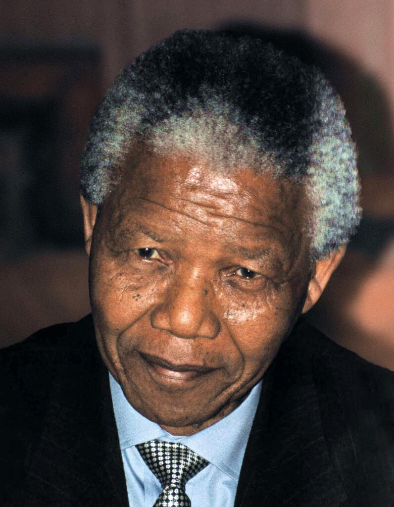 an informal portrait of Nelson Mandela, wearing a jacket and tie. He led the fight against apartheid in South Africa.