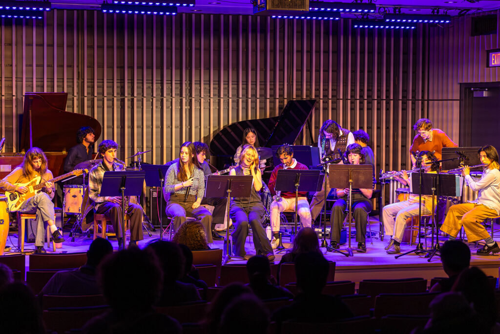 Purple and orange lighting highlight a jazz improvisation concert at Wu Hall.