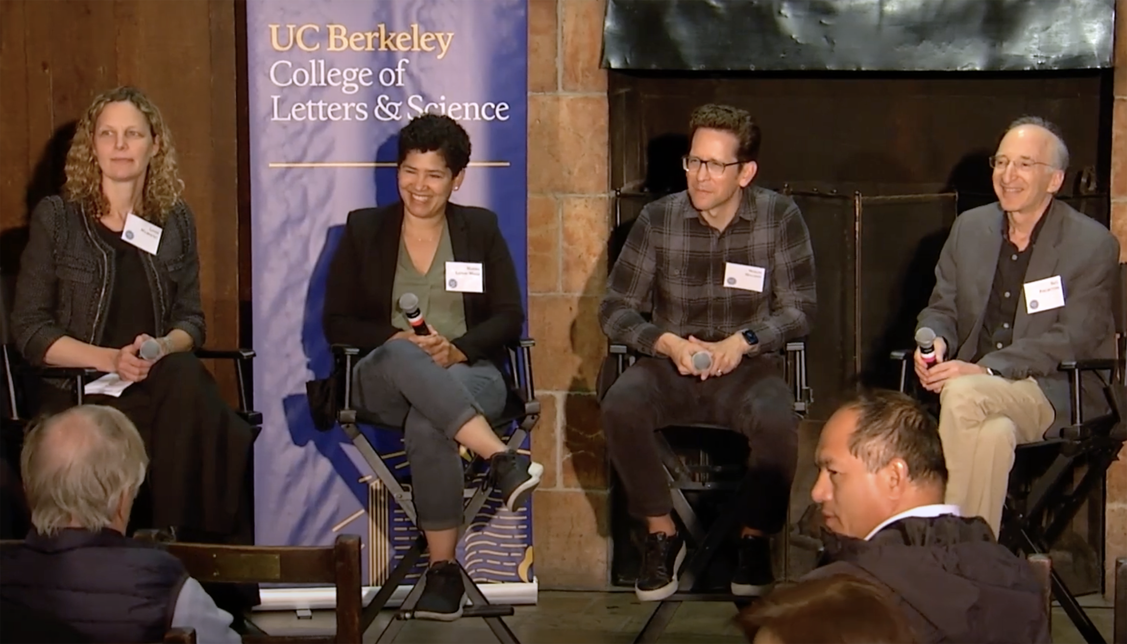 a panel of four Berkeley professors sit in front of an audience