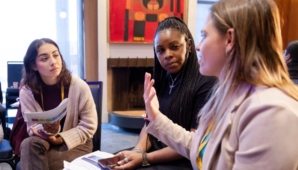 three women in a thoughtful, focused discussion