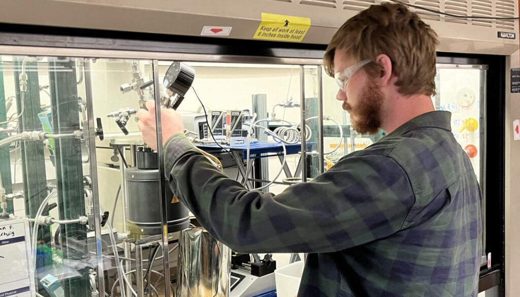 Graduate student RJ Conk works in a science lab