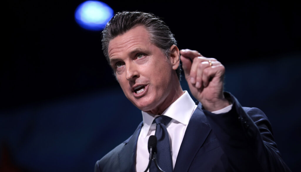 California Gov. Gavin Newsom gestures forcefully during a speech