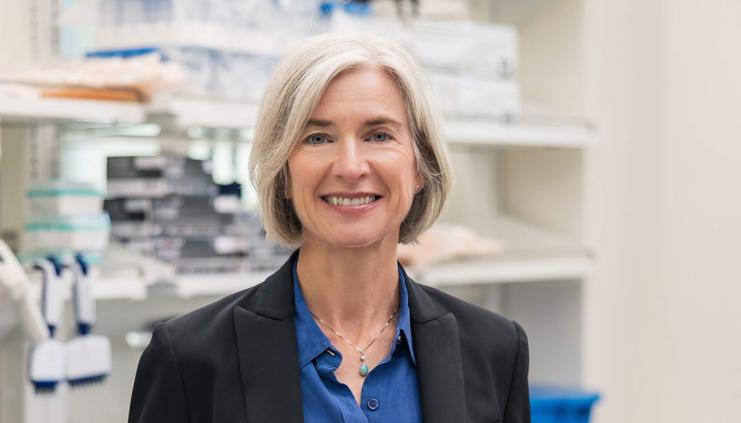 smiling woman in lab looking into camera