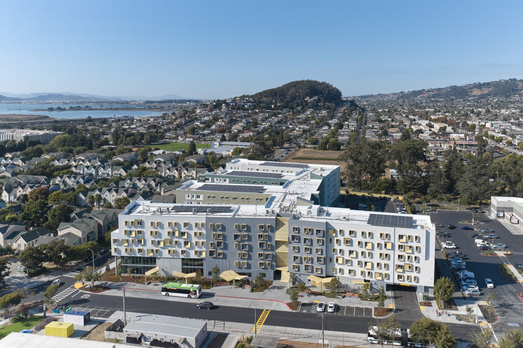 An aerial view of xučyun ruwway apartments with Albany Hill in the background.