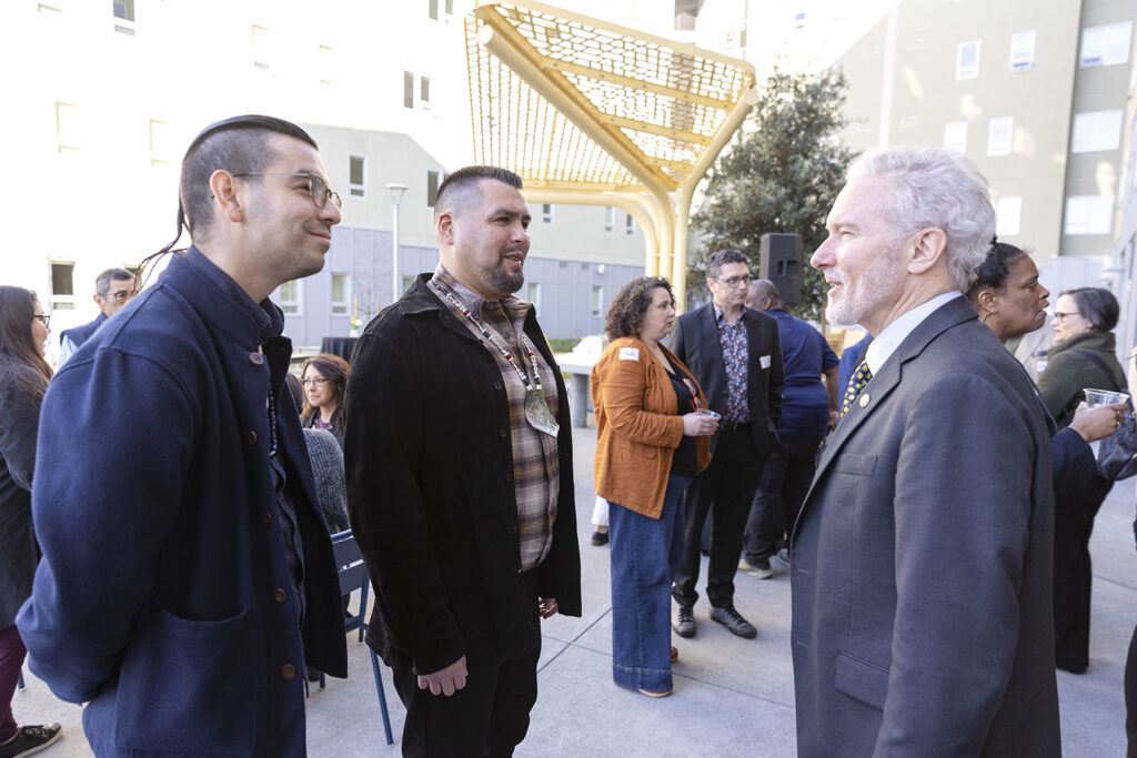 The leaders of Berkeley's 'ottoy initiative, which seeks to repair relationships between the campus and Indigenous people, speak with Chancellor Rich Lyons after a ceremony to celebrate the opening of xučyun ruwway, a new graduate student apartment complex.