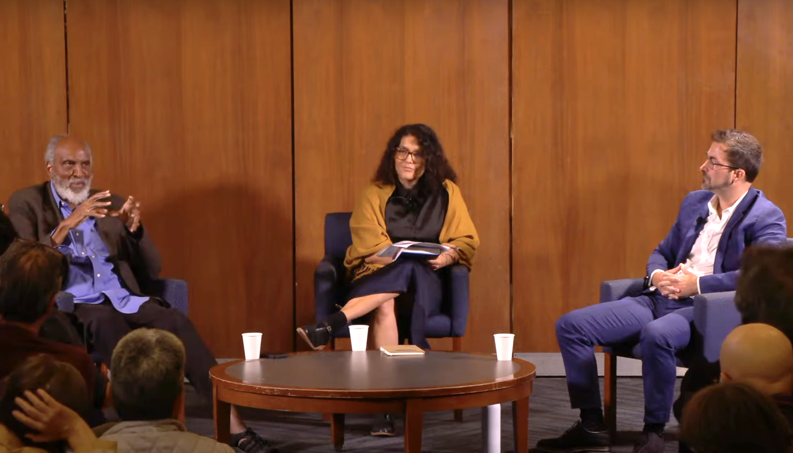 john powell, ashley gallegos and stephen menendian sit at the front of a room in front of an audience