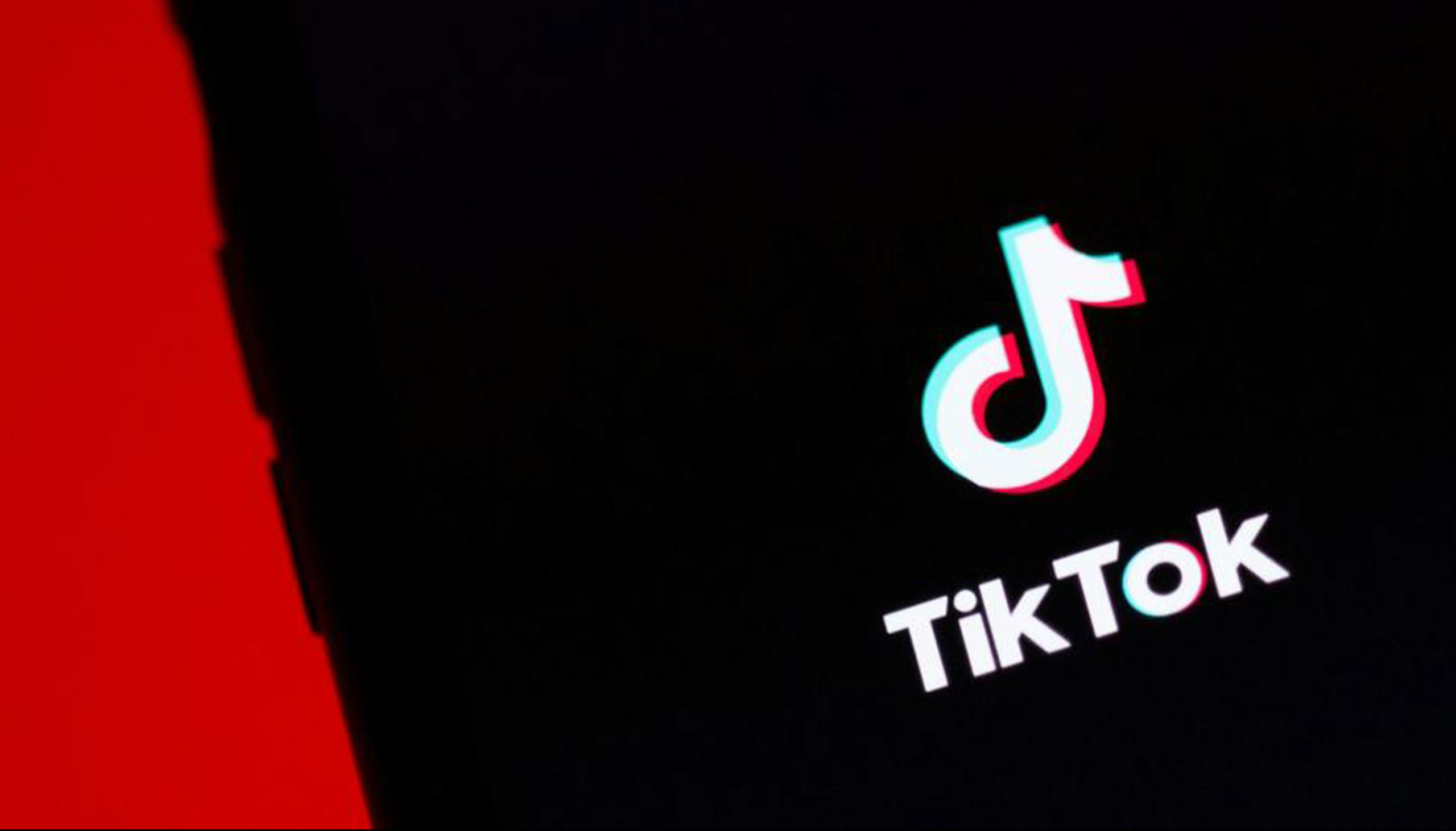 The TikTok logo next to a red background