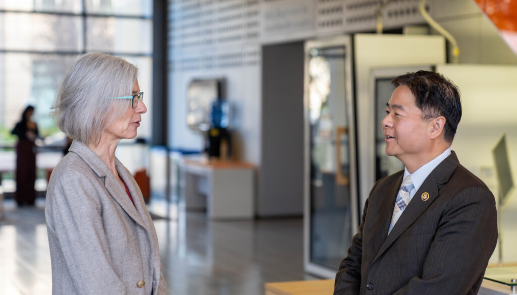 a woman and man talking in the lobby of a building