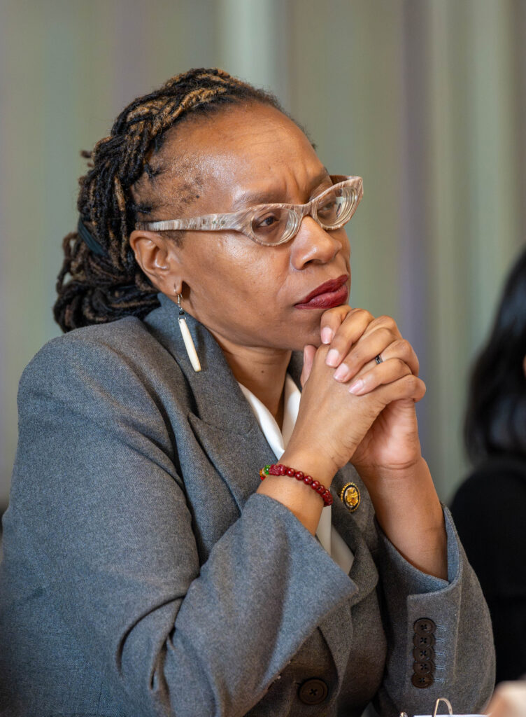 Woman with glasses looking intently into the distance