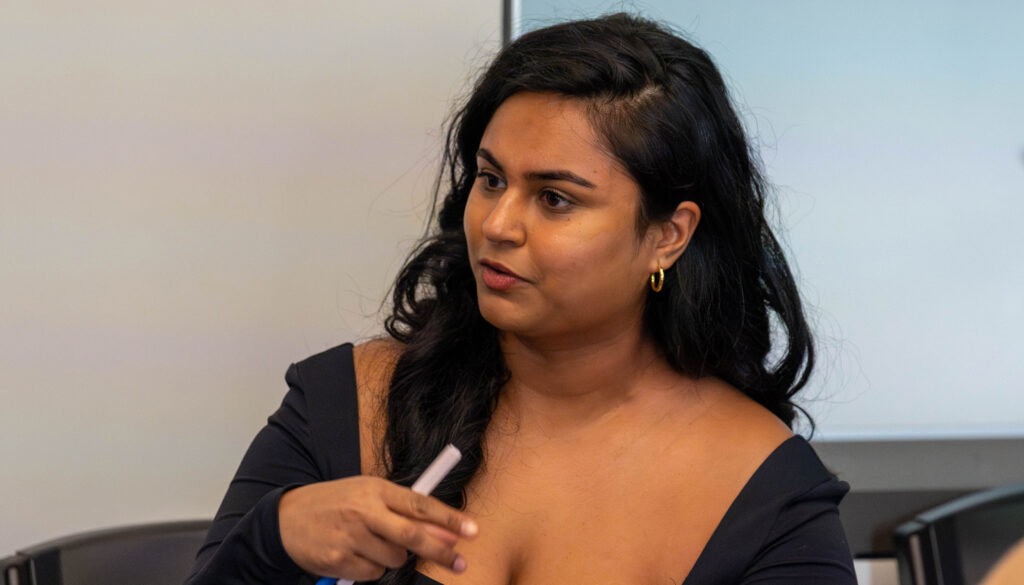 Young woman with black hair talking and gesturing