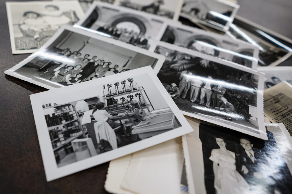 Black-and-white photographs from author Amy Tan's family, many shot by her father, John Tan, are in the Amy Tan archive acquired by UC Berkeley. An assortment of those photos is spread onto a table in this photo.